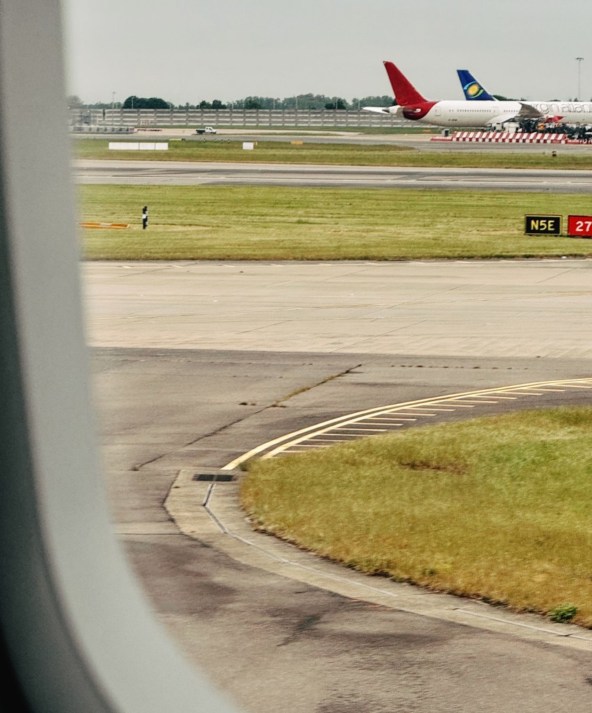 Looking out the window of an airplane. Other planes can be seen in the distance.